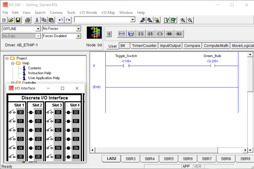 PLCLogix 500 ladder program with the Discrete I O interface positioned beside it before uploading